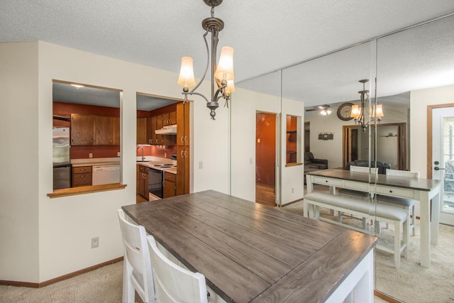 carpeted dining area with ceiling fan with notable chandelier, sink, and a textured ceiling