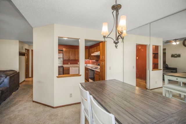 dining room with light carpet, a textured ceiling, ceiling fan with notable chandelier, and sink