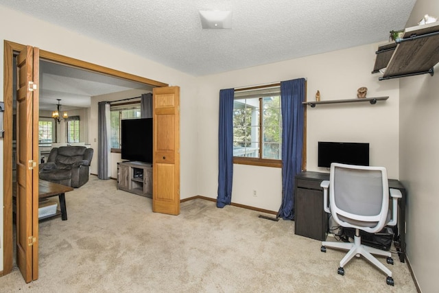 carpeted office space with a notable chandelier and a textured ceiling