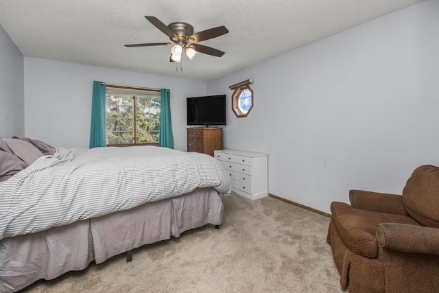 carpeted bedroom featuring a textured ceiling and ceiling fan