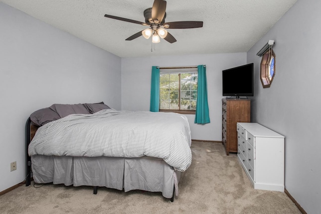 carpeted bedroom with a textured ceiling and ceiling fan