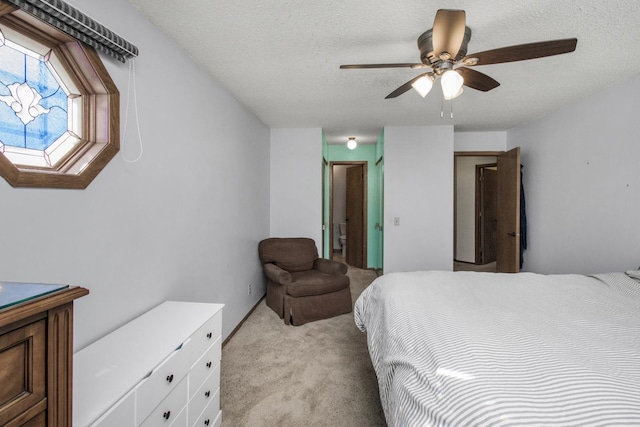 carpeted bedroom with ceiling fan and a textured ceiling