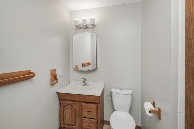 bathroom with vanity, a textured ceiling, and toilet