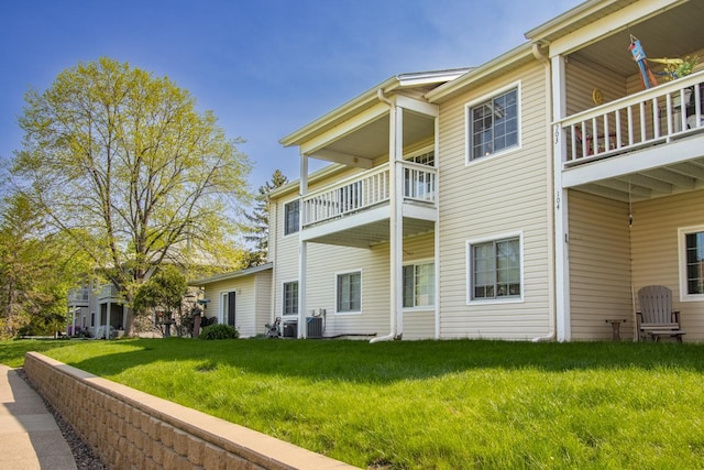 exterior space featuring a lawn, a balcony, and central AC