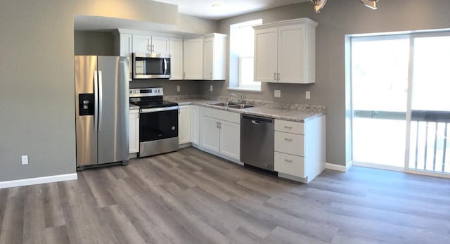 kitchen with white cabinetry, sink, and appliances with stainless steel finishes