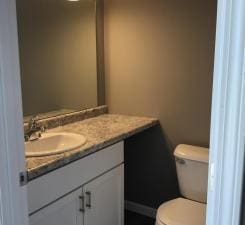 bathroom featuring vanity and toilet