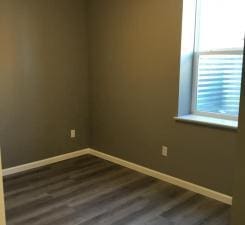 unfurnished room with dark hardwood / wood-style floors