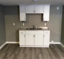 kitchen featuring white cabinetry and dark wood-type flooring