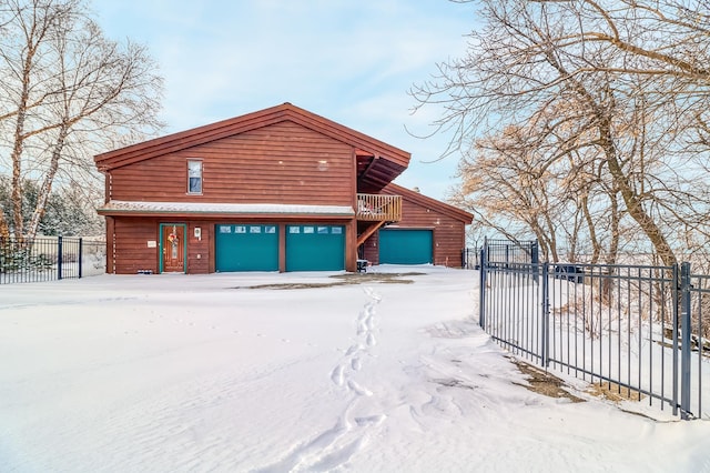 snow covered property featuring a garage