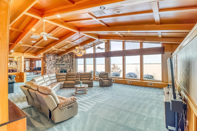 carpeted living room featuring ceiling fan with notable chandelier, lofted ceiling with beams, wood ceiling, and a fireplace