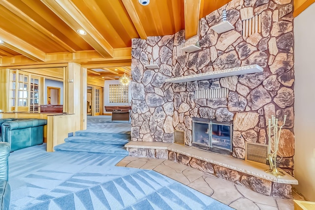 interior space with wooden ceiling, beam ceiling, a fireplace, and crown molding