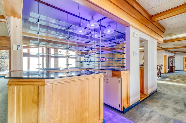 kitchen with light brown cabinets and dark carpet