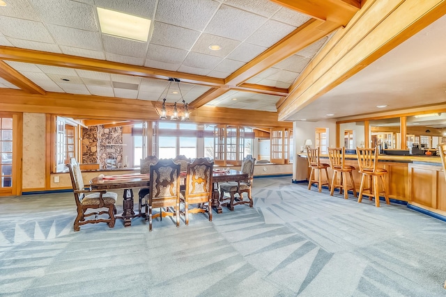 dining room with carpet floors and coffered ceiling