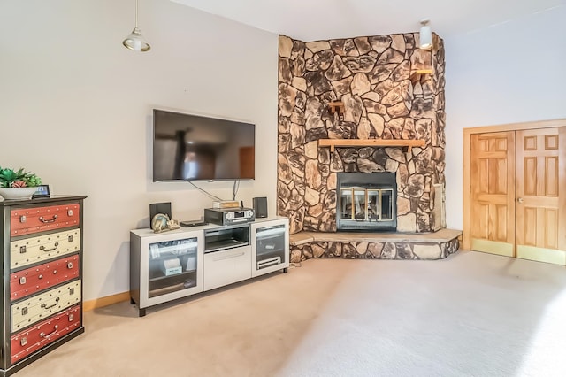 living room with light colored carpet and a stone fireplace