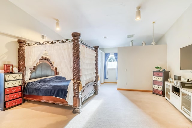 carpeted bedroom with vaulted ceiling