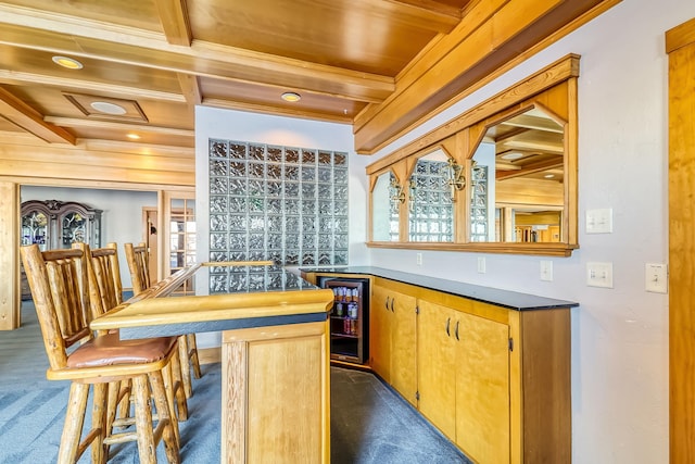 bar with wood ceiling, beverage cooler, dark carpet, and beamed ceiling