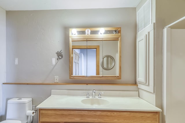 bathroom with toilet and vanity