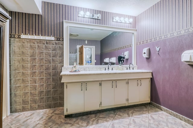 bathroom with a textured ceiling and vanity