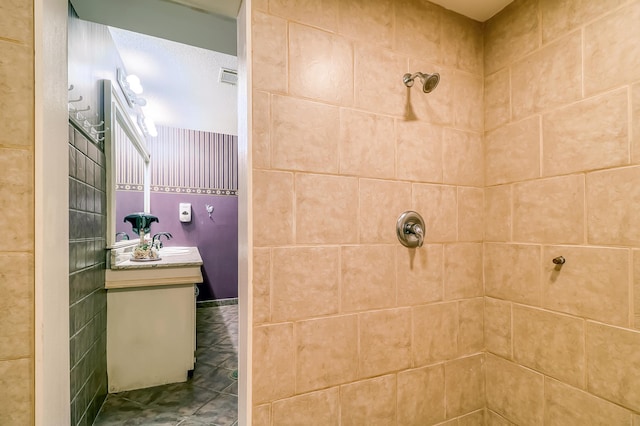 bathroom featuring vanity and a tile shower