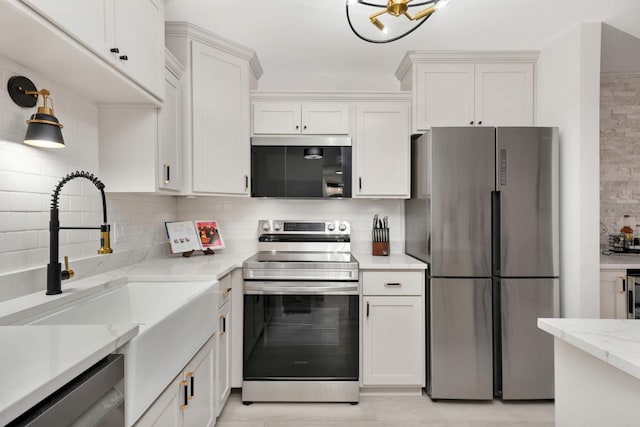 kitchen featuring white cabinets, backsplash, and stainless steel appliances