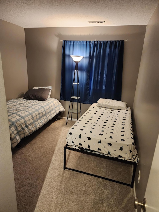 carpeted bedroom with a textured ceiling