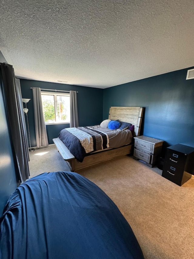 carpeted bedroom with a textured ceiling