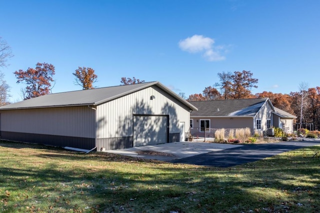 view of side of property featuring a yard and a garage