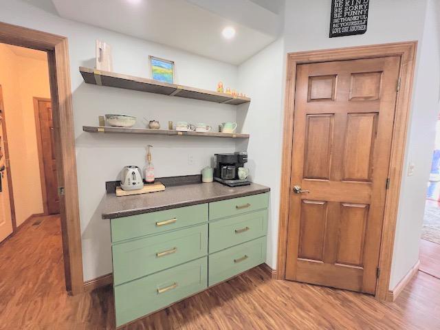 bar with light hardwood / wood-style flooring