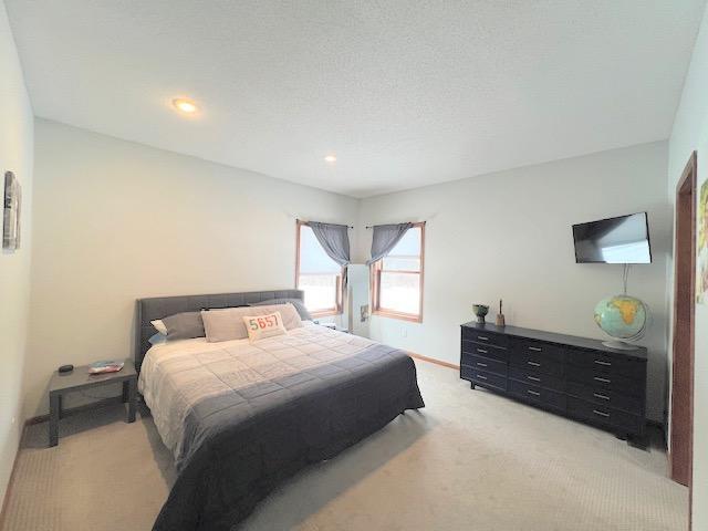 carpeted bedroom featuring a textured ceiling