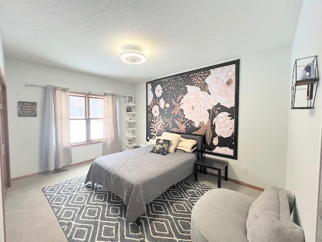 carpeted bedroom with a textured ceiling