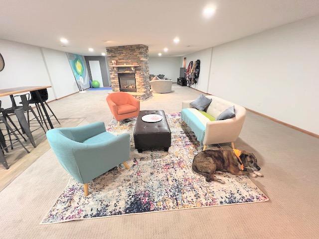 carpeted living room featuring a fireplace