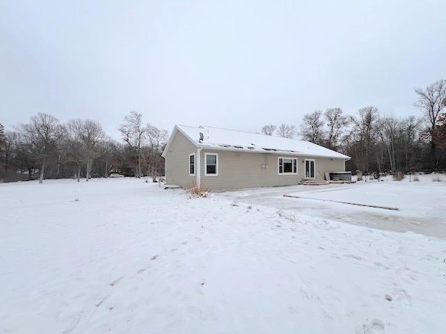 view of snow covered rear of property