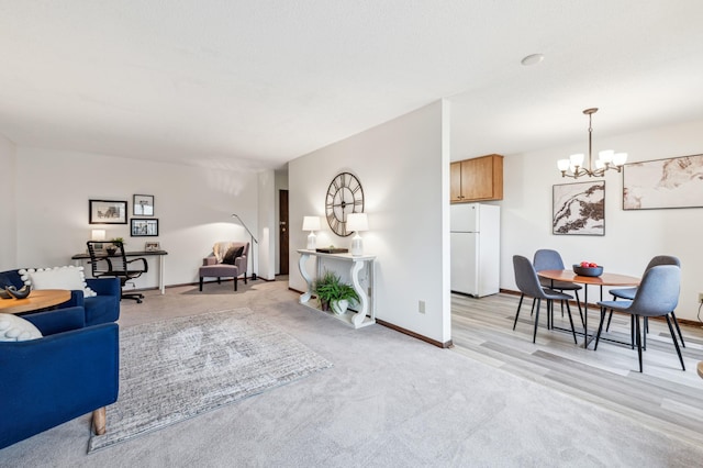 living room featuring a chandelier and light wood-type flooring