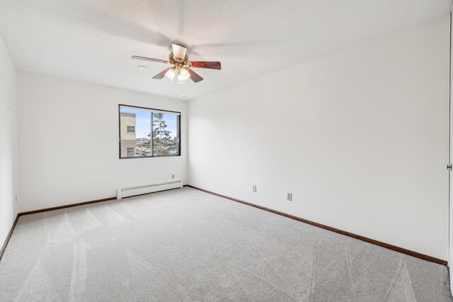 carpeted empty room featuring ceiling fan, a baseboard radiator, and a textured ceiling