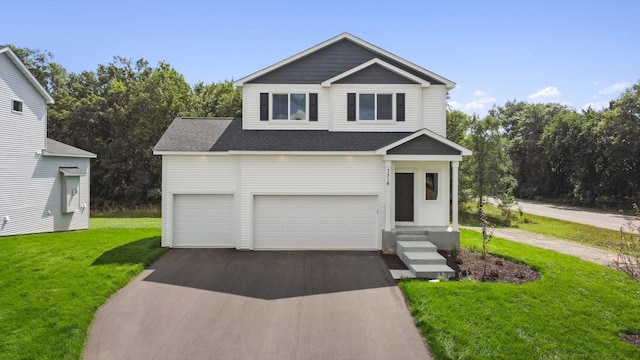 view of front of property featuring a front yard and a garage