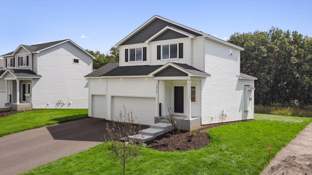 view of front of property with a front yard and a garage