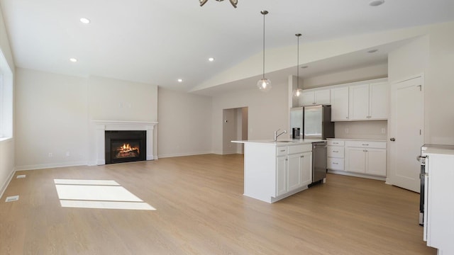 kitchen with white cabinetry, hanging light fixtures, and light hardwood / wood-style floors