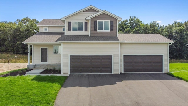 view of front of property with a garage and a front yard