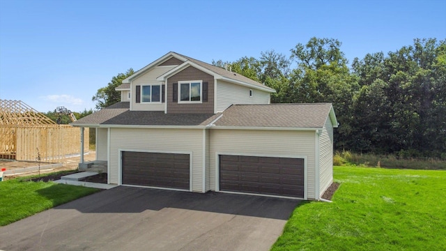 view of front facade featuring a front yard and a garage