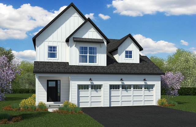 view of front of home with a front yard and a garage