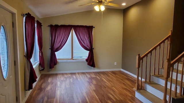 foyer entrance featuring hardwood / wood-style flooring, ceiling fan, and vaulted ceiling