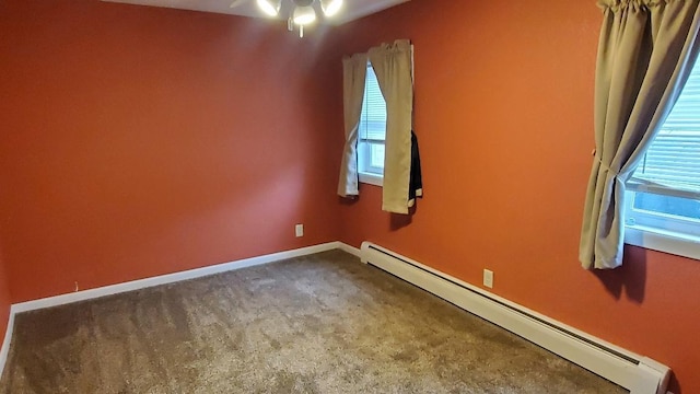 empty room with ceiling fan, a healthy amount of sunlight, and a baseboard radiator