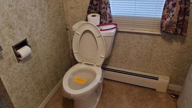 bathroom with baseboard heating and toilet