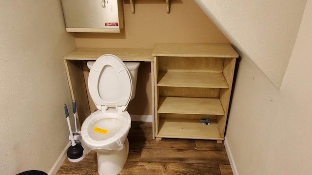 bathroom with wood-type flooring and toilet