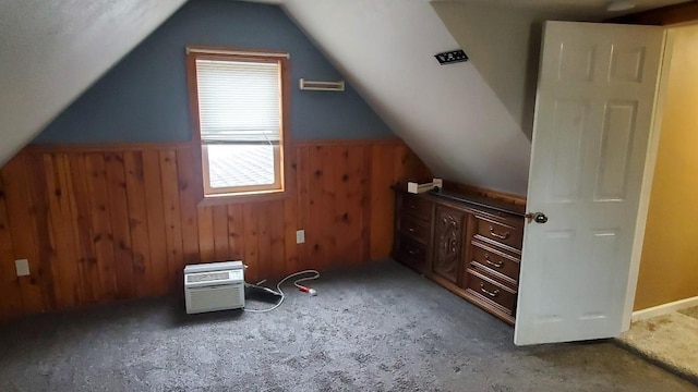 additional living space with wooden walls and lofted ceiling