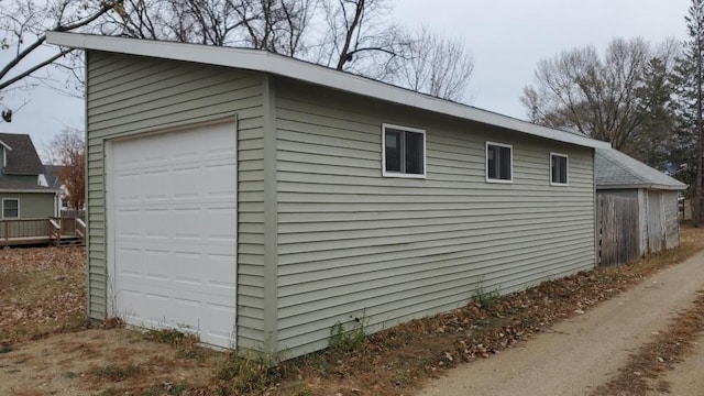 view of side of property with an outdoor structure and a garage