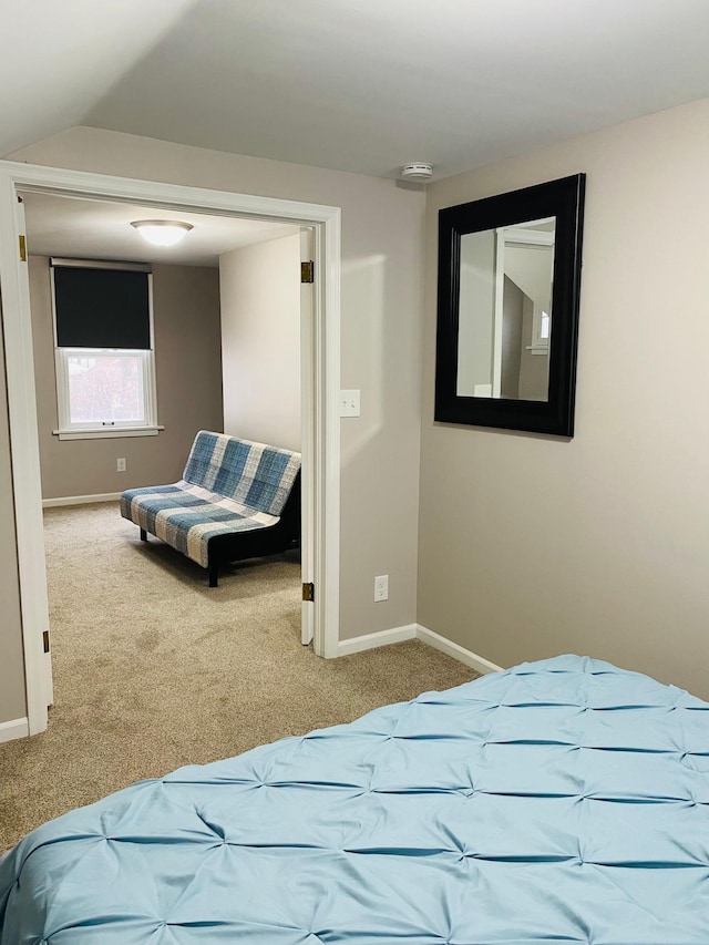 carpeted bedroom with vaulted ceiling