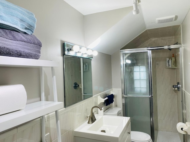 bathroom with a shower with door, vanity, and toilet