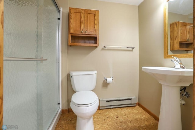 bathroom featuring toilet, a shower with door, and baseboard heating