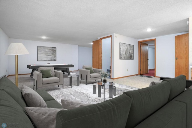 living room featuring carpet and a textured ceiling